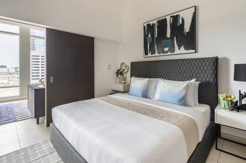 a hotel room with a large bed and a window at Frank Porter - The Lofts Central in Dubai