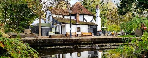 a house sitting on the side of a river at Little Acorns in Saint Albans