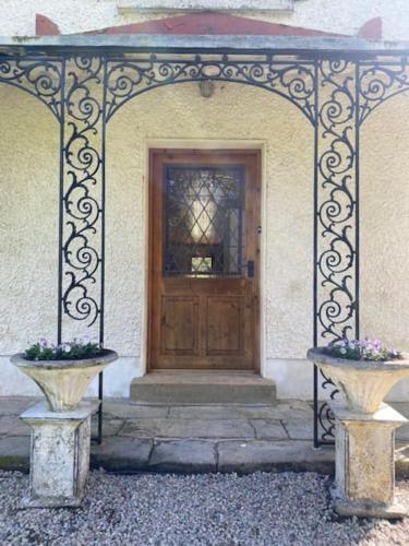an entrance to a building with a wooden door at The Gatelodge, Hilton Park in Monaghan