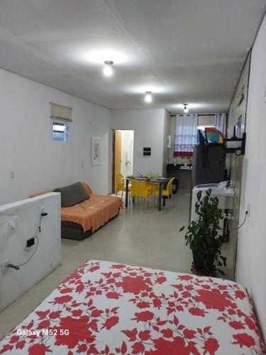 a living room with a bed and a table at Studio com varanda - Melhor localização do Arruda in Recife