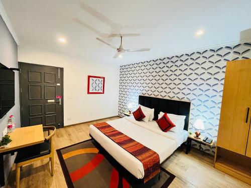 En eller flere senge i et værelse på Qotel Hotel Chhatarpur- Opp Tivoli garden