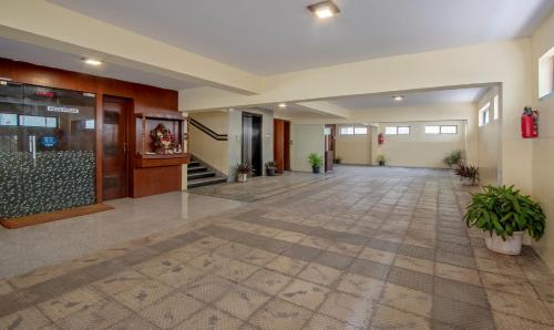 an empty lobby of a building with plants in it at Treebo Marina Grand, Railway station in Visakhapatnam