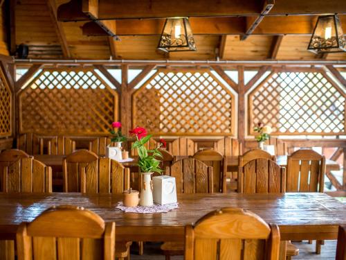 a dining room with a wooden table and chairs at Hotel&SPA Pysanka, Готель Писанка, 3 сауни та джакузі - індивідуальний відпочинок у СПА in Lviv