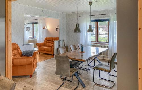 a dining room and living room with a table and chairs at 5 Bedroom Amazing Home In Tingsryd in Tingsryd