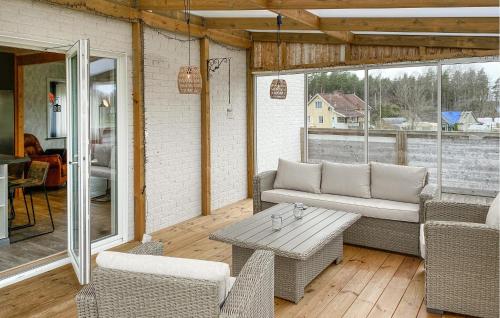 a screened in porch with a couch and a table at 5 Bedroom Amazing Home In Tingsryd in Tingsryd