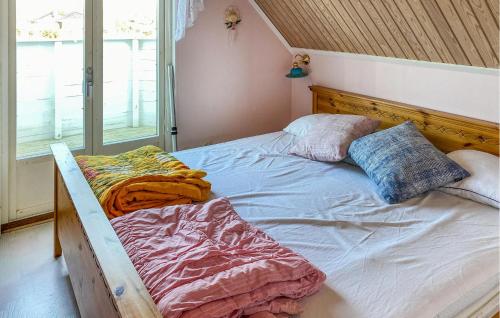 an unmade bed in a bedroom next to a window at 5 Bedroom Stunning Home In Köpingsvik in Köpingsvik