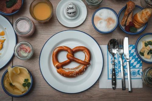 a plate of food with a pretzel on a table at Cocoon Hauptbahnhof in Munich