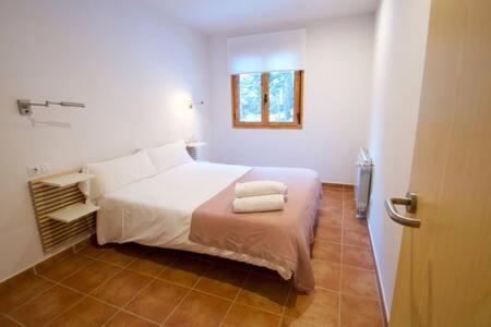 1 dormitorio con 1 cama con 2 toallas en Apartamento Supermolina Esquí, en La Molina