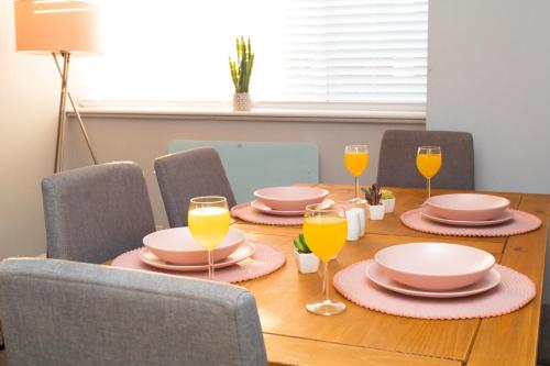 a table with plates and glasses of orange juice at Bloomfield Apartments in Blackpool