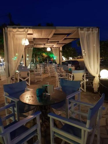 a group of chairs and a table with a tent at To Kyma in Moudhros