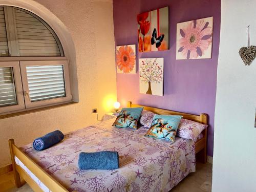 a bedroom with a bed with pillows on it at Villa Lory Krk in Krk