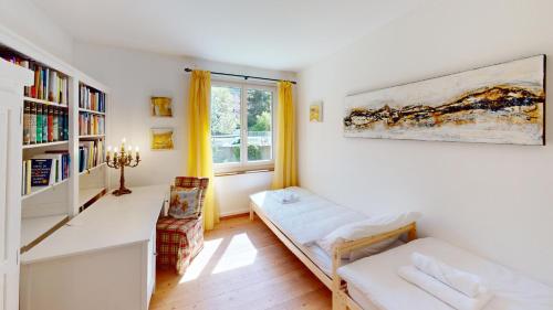 a living room with a couch and a window at 4 Zimmerwohnung mit grossem Garten in Chur