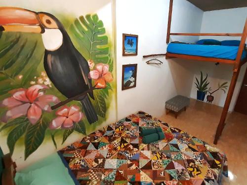 a bedroom with a bird painting on the wall at L'isola che... in Karimunjawa