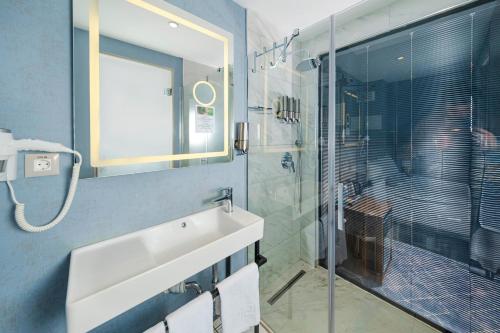 a bathroom with a sink and a glass shower at Ring Stone Hotels Bosphorus - Special Class in Istanbul