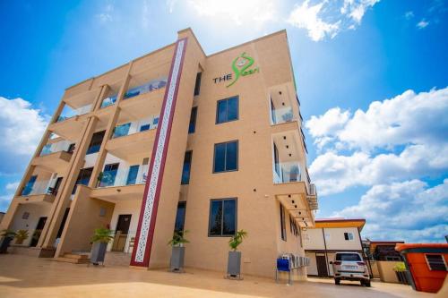 a building with a sign on the side of it at The Pearl - Bountiful - 2nd floor in Kumasi