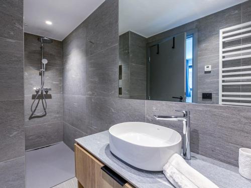 a bathroom with a sink and a mirror at Appartement Val-d'Isère, 3 pièces, 4 personnes - FR-1-694-331 in Val-d'Isère