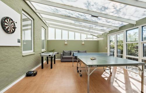 a ping pong table in a room with windows at Gorgeous Home In Marstal With Wifi in Marstal