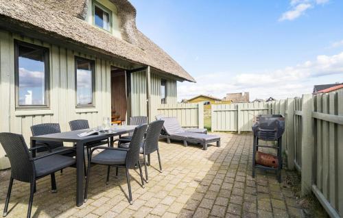 Un patio con mesa y sillas y parrilla. en Awesome Home In Harboøre With Wifi, en Harboør