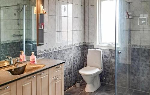 a bathroom with a toilet and a shower and a sink at Beautiful Apartment In Hellvik With House Sea View in Hellvik
