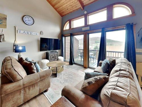 a living room with a couch and a clock on the wall at Sunplace 30 in McHenry
