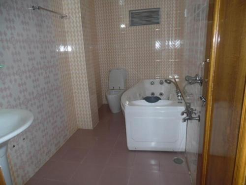 a bathroom with a toilet and a sink at Excelsior Sylhet Hotel & Resort in Sylhet