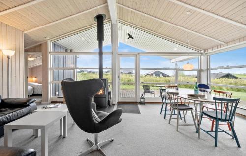 a living room with a table and a chair at Stunning Home In Frørup With Kitchen in Frørup