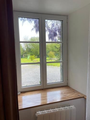 two windows in a room with a wooden window sill at Studio indépendant avec jardin privatif in Le Lorey
