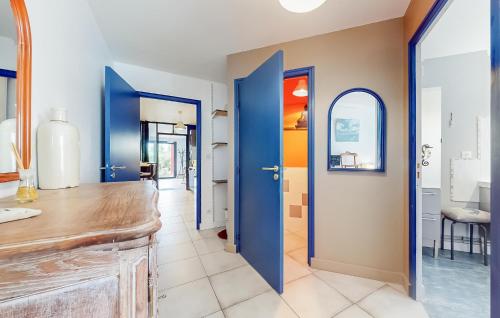 a hallway with blue doors in a house at Cozy Apartment In Sainte-adresse With Wifi in Sainte-Adresse
