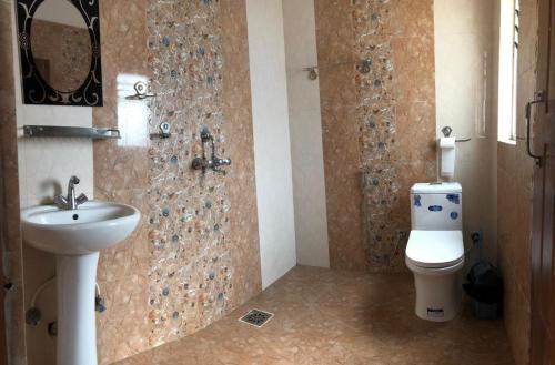 a bathroom with a sink and a toilet at Green Mandala Inn in Kathmandu