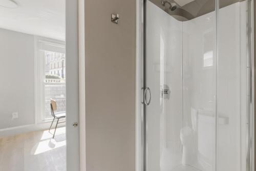 a shower in a bathroom with a glass door at Beacon Hill studio nr boston common shops BOS-906 in Boston