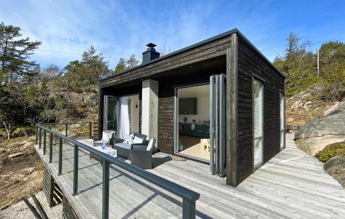 a small wooden house on a wooden deck at Awesome Home In Skjærhalden in Skjærhollen