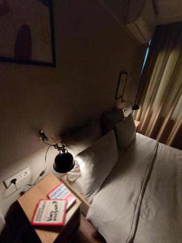 a bedroom with a bed and a table with a lamp at Balta Hotel in Edirne