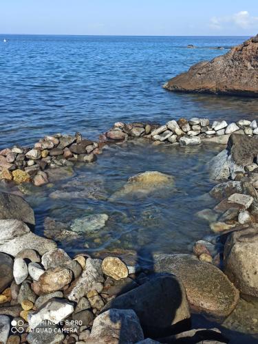 a group of rocks on the shore of the water at Lacazavanoo in Baillif