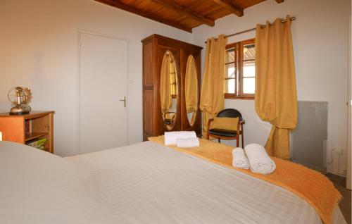 a bedroom with a large bed with towels on it at 2 Bedroom Stunning Home In Popolasca in Popolasca