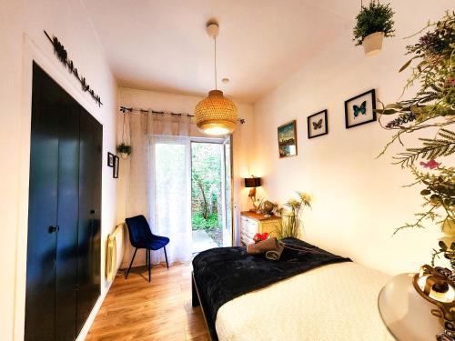 a bedroom with a bed and a large window at Le Chateau in Angers