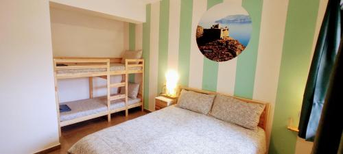 a bedroom with a bed and two bunk beds at Ai Laghi Bed&Bed in Messina