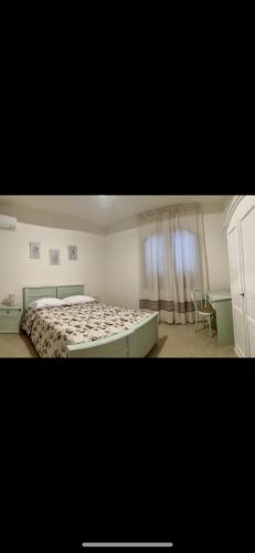 a bedroom with a bed and a chair in it at DoMu’ in Seùlo