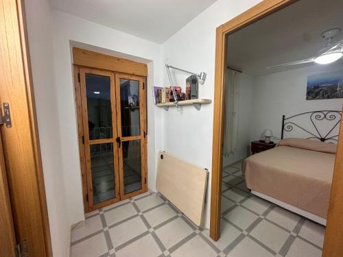 a bedroom with a bed and a door leading into a room at Casa Patricia en Fuencaliente con Piscina privada Climatizada in Fuencaliente