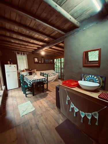 a living room with a kitchen and a dining room at CABAÑA en Eco Posada Tierra Fértil in Santa Ana
