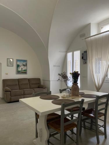 a living room with a table and a couch at Masseria Don Sante in Fasano