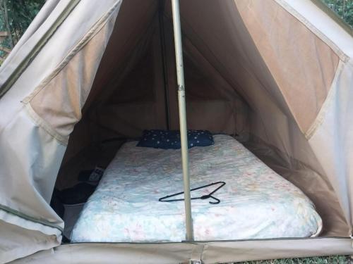 a bed inside of a tent with a mattress at Stone Camp Naivasha in Naivasha