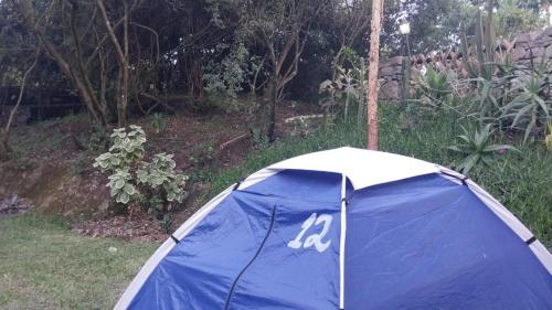 a blue and white tent sitting in a yard at Stone Camp Naivasha in Naivasha