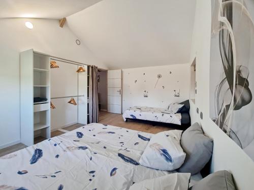 a bedroom with a large bed and a couch at les piafs du der 1 in Joncreuil