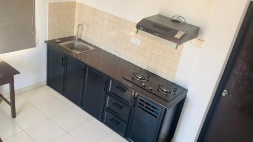 a small kitchen with a sink and a stove at Beverly Hills Hotel in Mount Lavinia