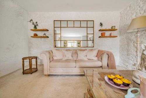 a living room with a couch and a table at Live the coastal cottage dream in Dorset AONB in Weymouth