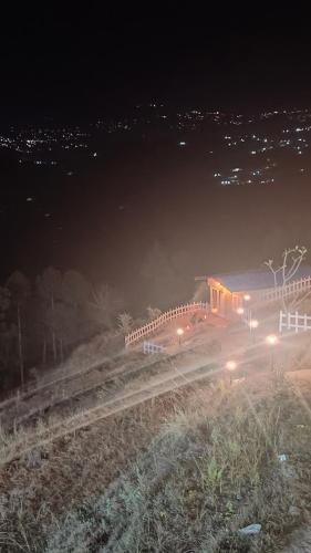 a train station on the tracks at night at Adaara Retreat - Pet Friendly Cottages, Almora in Almora
