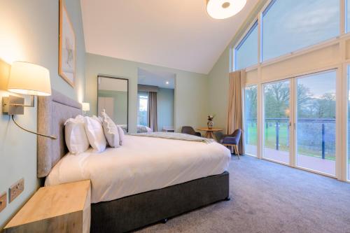 a bedroom with a large bed and a large window at Killeen Castle in Dunsany