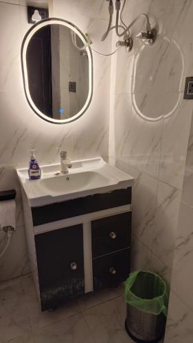 a bathroom with a sink and a mirror at Adaara Retreat - Pet Friendly Cottages, Almora in Almora