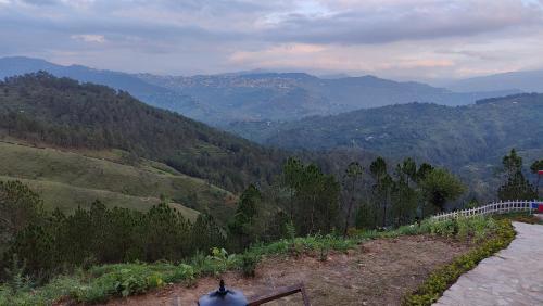 a view of a valley with mountains and a street light at Adaara Retreat - Pet Friendly Cottages, Almora in Almora
