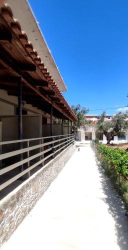 a walkway next to a building with a fence at Karavaki apartments in Keri